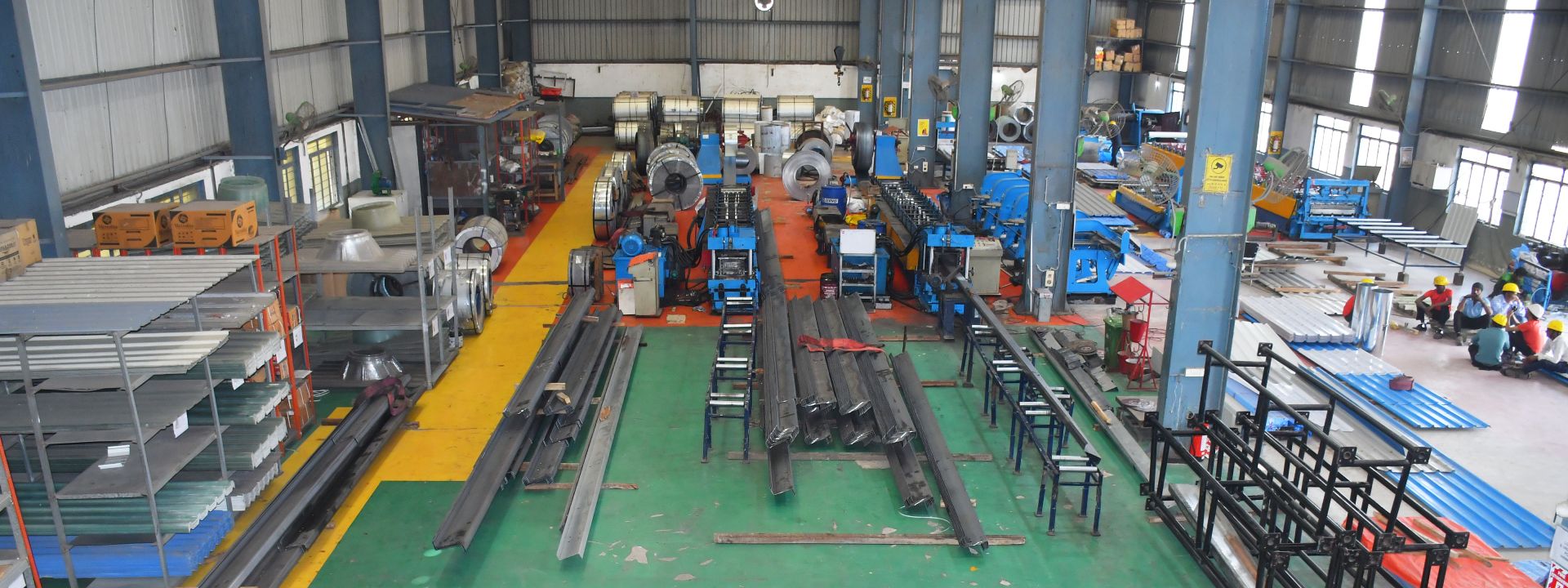 Coils, stacked purlins and roll-formed sheets on the MNF shop floor